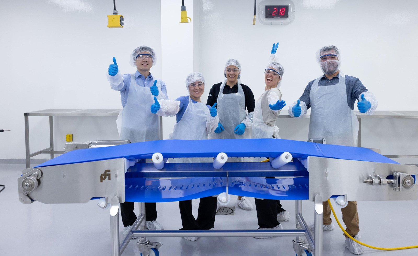 Commercial Food Sanitation's Food Safety Specialists on a plant floor, giving a thumbs-up